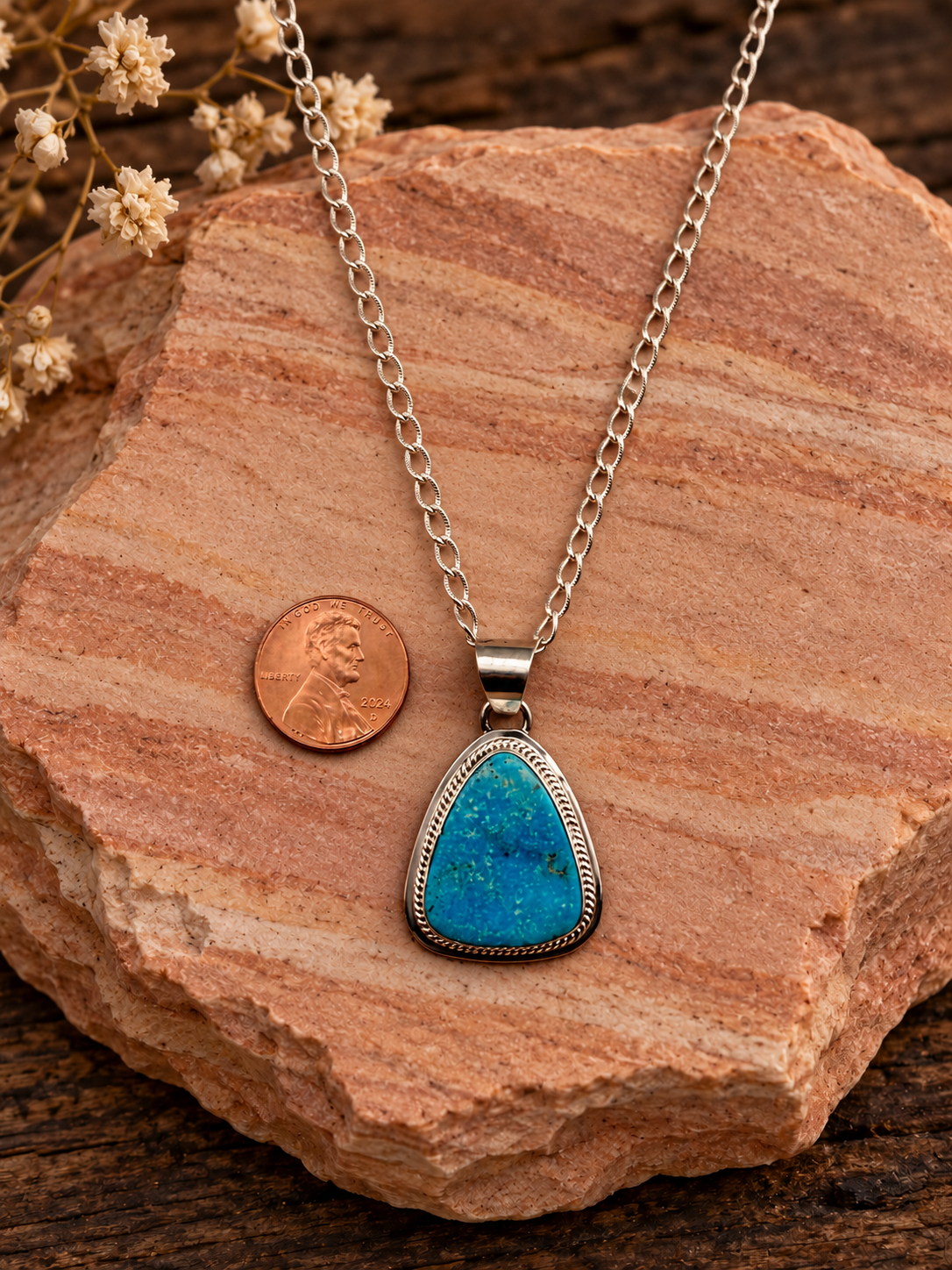 Kingman turquoise pendant with included sterling silver chain and penny on rose sandstone
