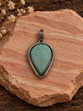 Pale turquoise teardrop sterling silver pendant with coiled silver border on rose sandstone