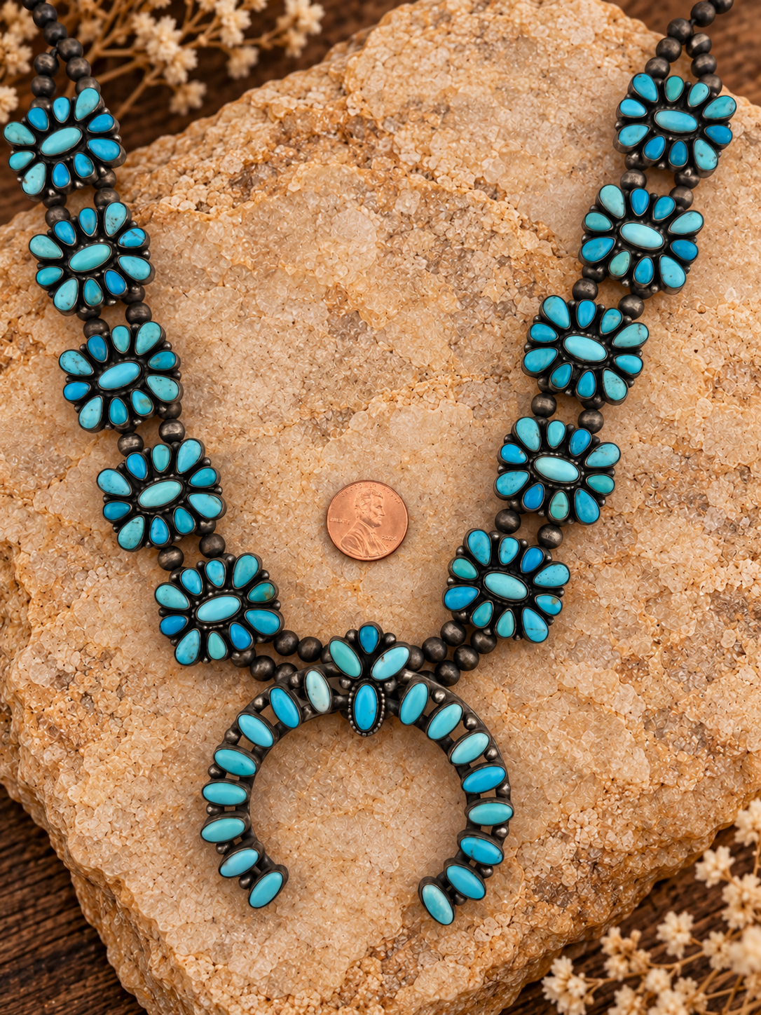 P. Johnson turquoise cluster necklace detail with styled stone background