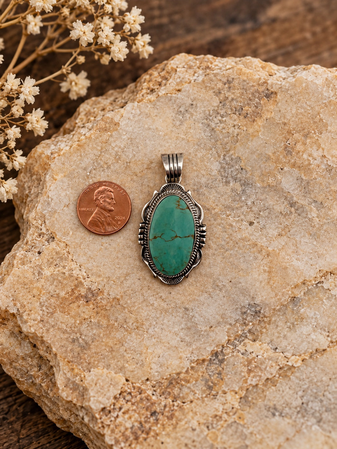 Oval Turquoise Sterling Silver Pendant shown beside a penny for scale