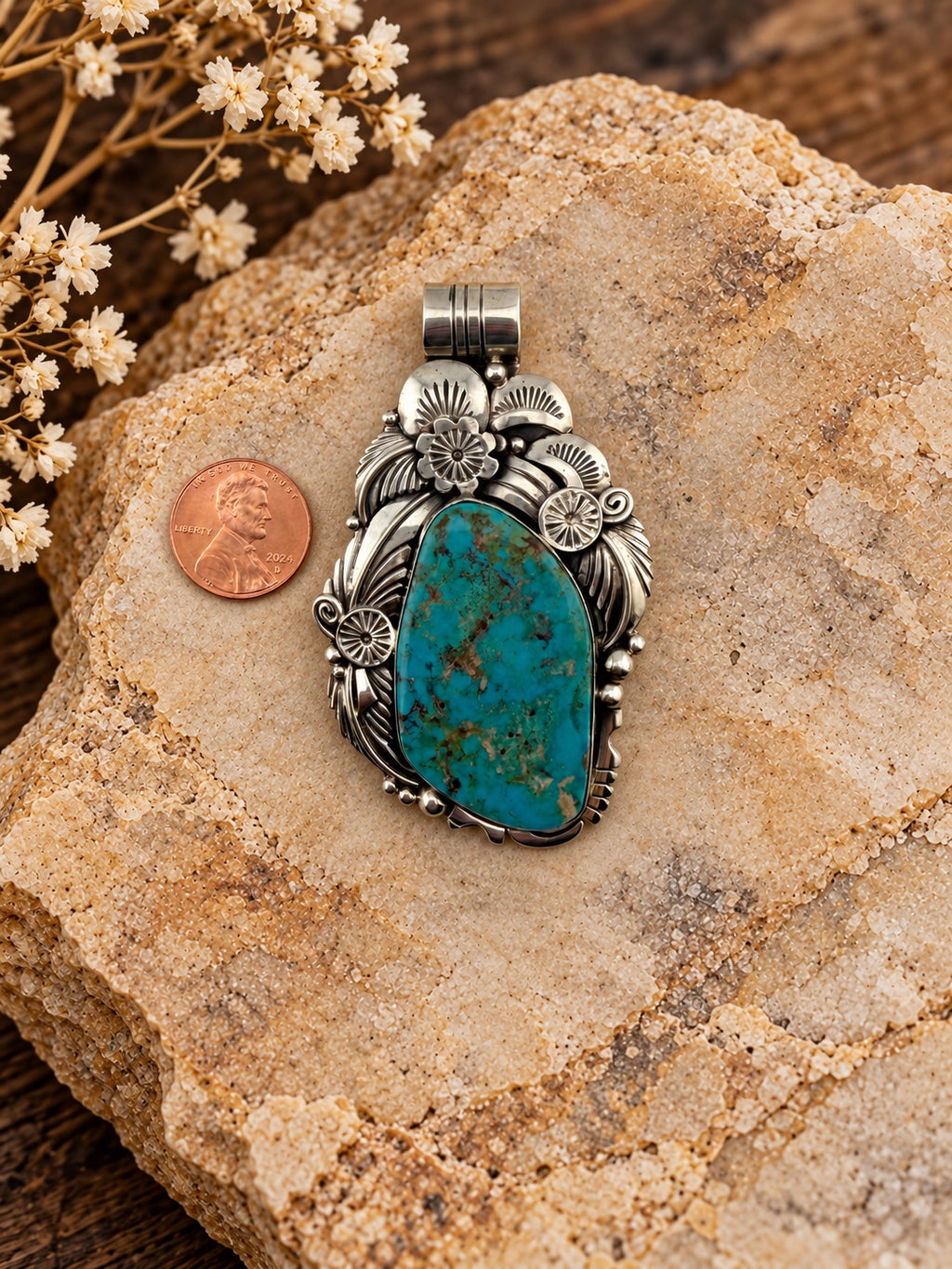 Floral Turquoise Sterling Silver Pendant shown beside a penny for scale