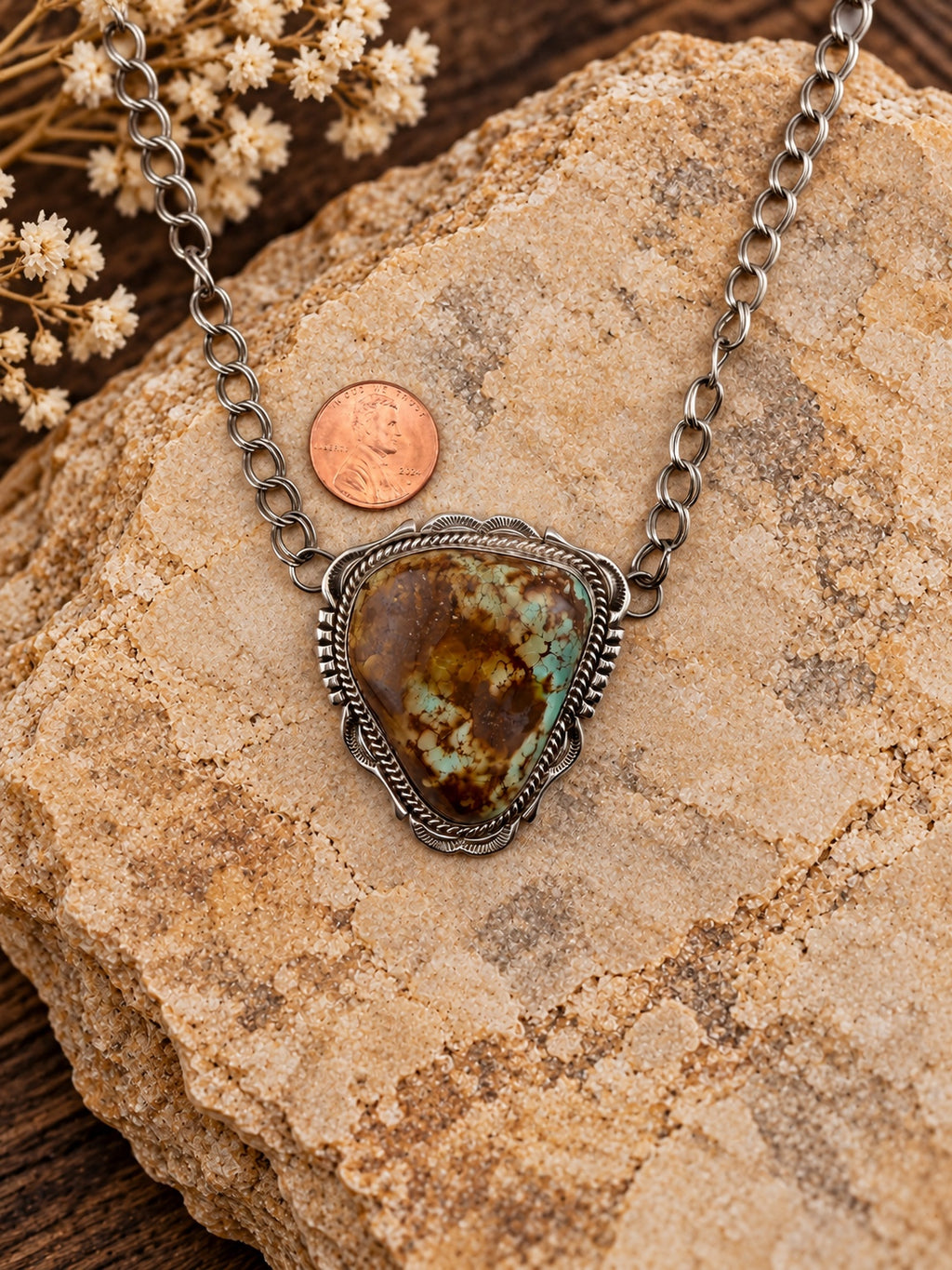 Triangular Turquoise Sterling Silver Pendant shown beside a penny for scale