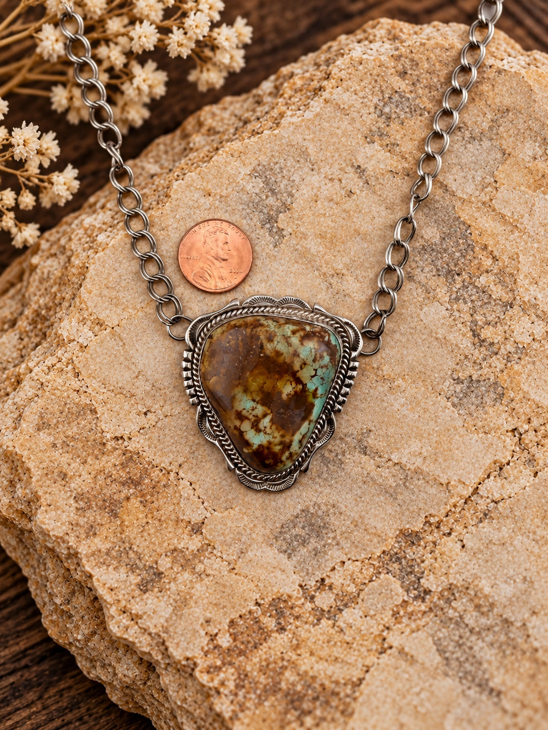 Triangular Turquoise Sterling Silver Pendant shown beside a penny for scale
