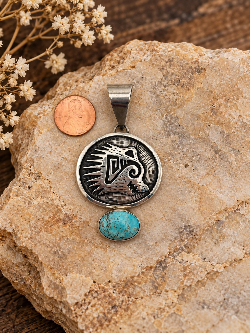 Turquoise Animal-Design Sterling Silver Pendant shown beside a penny for scale