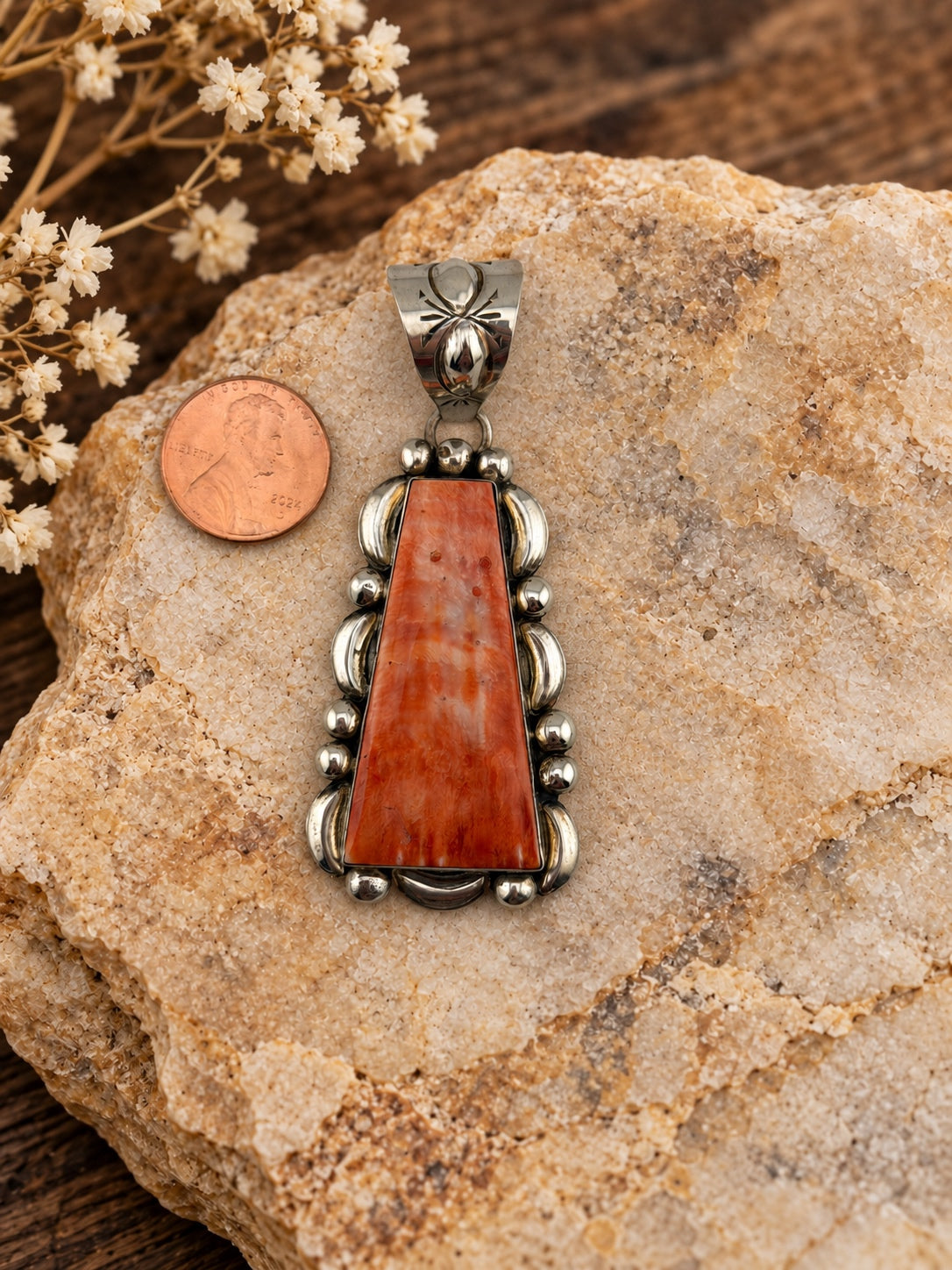 Elongated Spiny Oyster Sterling Silver Pendant shown beside a penny for scale